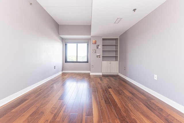 111 N Ashley St Unit 412, Ann Arbor, MI 48104 - empty room featuring dark wood-style flooring, built in features, and fire sprinkler in ceiling