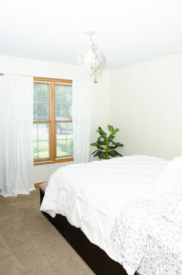 11734 Lindy Ct, Rockford, MI 49341 - bedroom featuring carpet and a chandelier