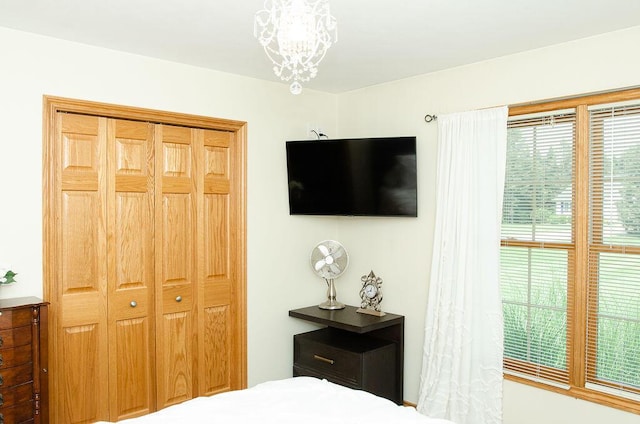 11734 Lindy Ct, Rockford, MI 49341 - bedroom with multiple windows and a chandelier
