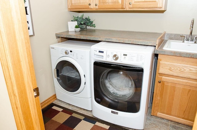 11734 Lindy Ct, Rockford, MI 49341 - laundry area with cabinet space, washer and clothes dryer, and tile patterned floors