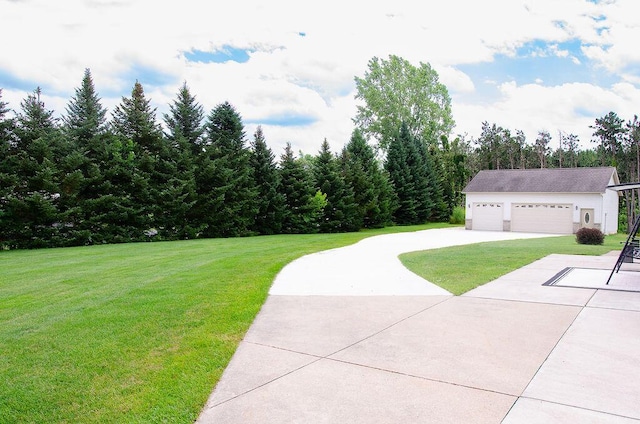11734 Lindy Ct, Rockford, MI 49341 - view of grassy yard featuring an outdoor structure and concrete driveway
