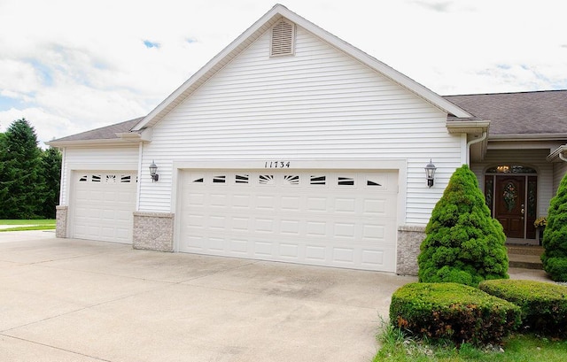 11734 Lindy Ct, Rockford, MI 49341 - garage featuring driveway