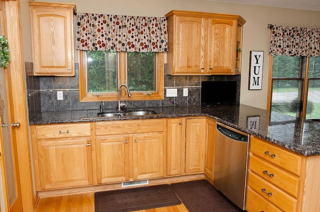 11734 Lindy Ct, Rockford, MI 49341 - kitchen featuring dishwasher, dark stone counters, a peninsula, tasteful backsplash, and plenty of natural light