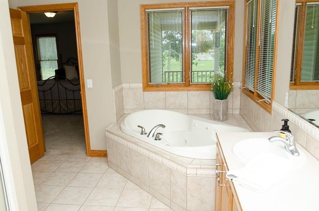 11734 Lindy Ct, Rockford, MI 49341 - bathroom featuring a tub with jets, vanity, and tile patterned floors