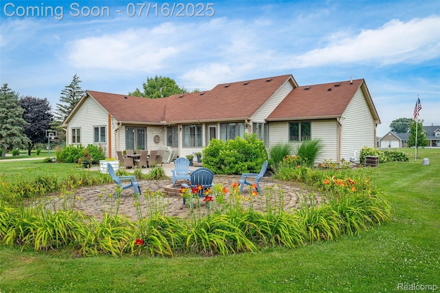 7366 E Maple Ave, Grand Blanc, MI 48439 - rear view of house with a patio area, a lawn, an outdoor fire pit, and a shingled roof