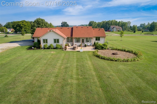 7366 E Maple Ave, Grand Blanc, MI 48439 - back of house with a patio area, a lawn, and driveway