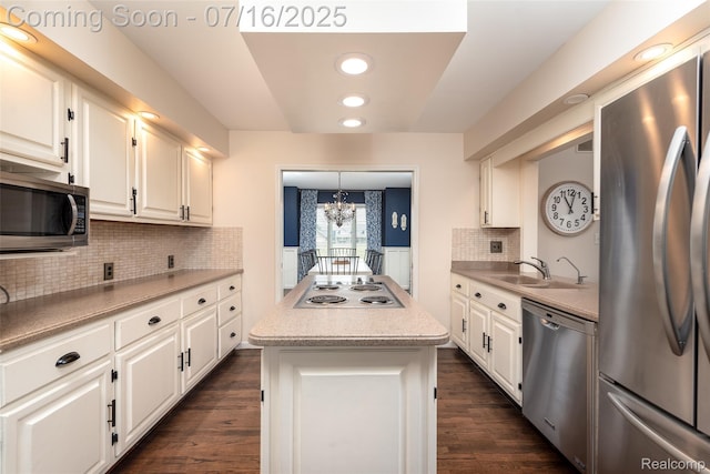 7366 E Maple Ave, Grand Blanc, MI 48439 - kitchen featuring appliances with stainless steel finishes, a chandelier, white cabinets, a center island, and light countertops