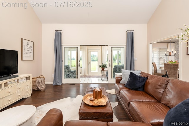 7366 E Maple Ave, Grand Blanc, MI 48439 - living room featuring wood finished floors, a chandelier, and lofted ceiling