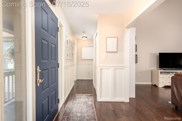 7366 E Maple Ave, Grand Blanc, MI 48439 - foyer entrance featuring dark wood finished floors, a decorative wall, and wainscoting
