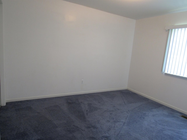 4237 W Grand Blanc Rd, Swartz Creek, MI 48473 - carpeted spare room featuring baseboards