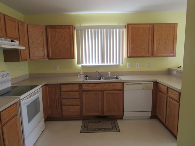 4237 W Grand Blanc Rd, Swartz Creek, MI 48473 - kitchen with white appliances, under cabinet range hood, brown cabinetry, and light countertops