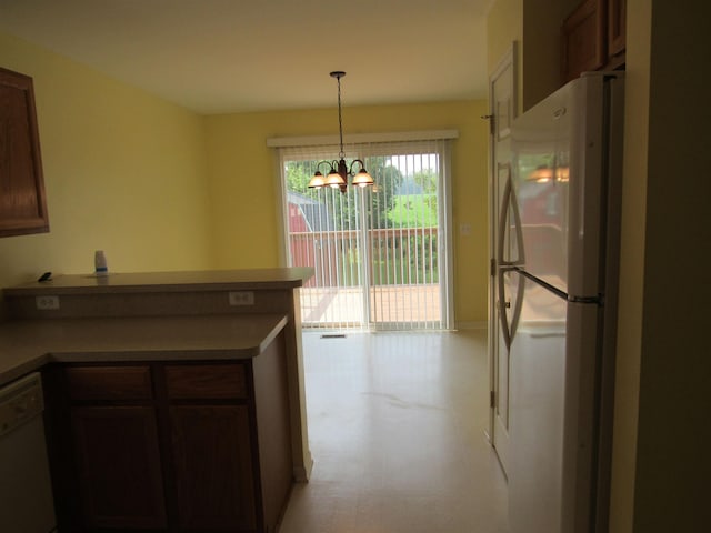 4237 W Grand Blanc Rd, Swartz Creek, MI 48473 - kitchen with white appliances, a chandelier, a peninsula, and hanging light fixtures
