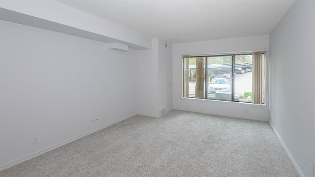 2124 Pauline Blvd Unit 206, Ann Arbor, MI 48103 - spare room featuring light carpet and baseboards