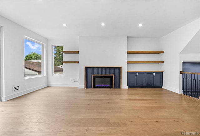 227 W Houstonia Ave, Royal Oak, MI 48073 - unfurnished living room featuring a glass covered fireplace, light wood finished floors, and recessed lighting
