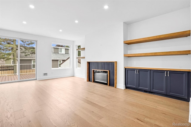 227 W Houstonia Ave, Royal Oak, MI 48073 - unfurnished living room featuring a glass covered fireplace, light wood-type flooring, and recessed lighting