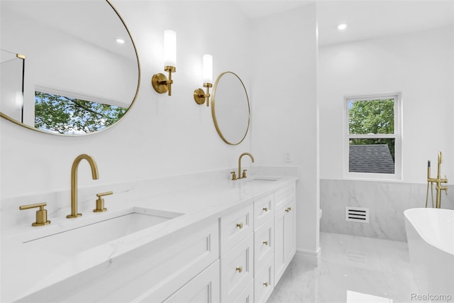 227 W Houstonia Ave, Royal Oak, MI 48073 - bathroom with double vanity, marble finish floors, a freestanding tub, and recessed lighting