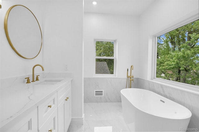 227 W Houstonia Ave, Royal Oak, MI 48073 - bathroom with vanity, a soaking tub, marble finish flooring, a wainscoted wall, and recessed lighting