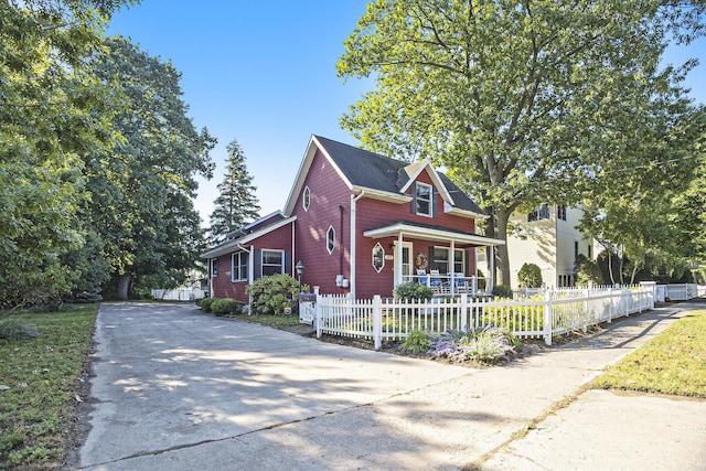 220 Park Ave, South Haven, MI 49090 - view of front of property with a porch, concrete driveway, and a fenced front yard