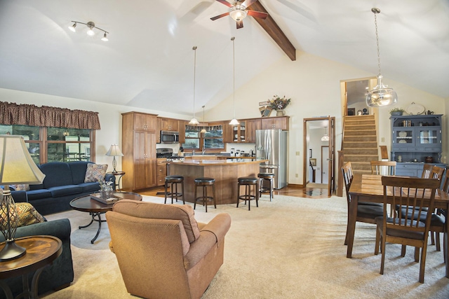 220 Park Ave, South Haven, MI 49090 - living room with a ceiling fan, beam ceiling, light colored carpet, stairway, and high vaulted ceiling