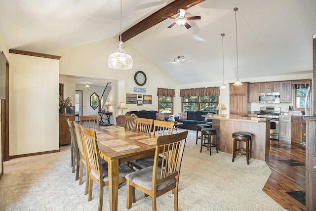 220 Park Ave, South Haven, MI 49090 - dining space with beamed ceiling, a ceiling fan, high vaulted ceiling, and wood finished floors