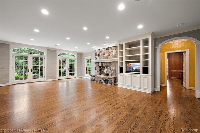 400 Hamilton Rd, Bloomfield, MI 48301 - unfurnished living room featuring ornamental molding, recessed lighting, wood finished floors, french doors, and a stone fireplace