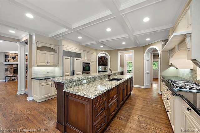 400 Hamilton Rd, Bloomfield, MI 48301 - kitchen featuring appliances with stainless steel finishes, a kitchen island with sink, arched walkways, recessed lighting, and tasteful backsplash