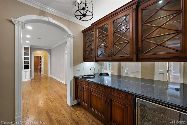 400 Hamilton Rd, Bloomfield, MI 48301 - indoor wet bar with arched walkways, ornate columns, beverage cooler, ornamental molding, and light wood-style floors