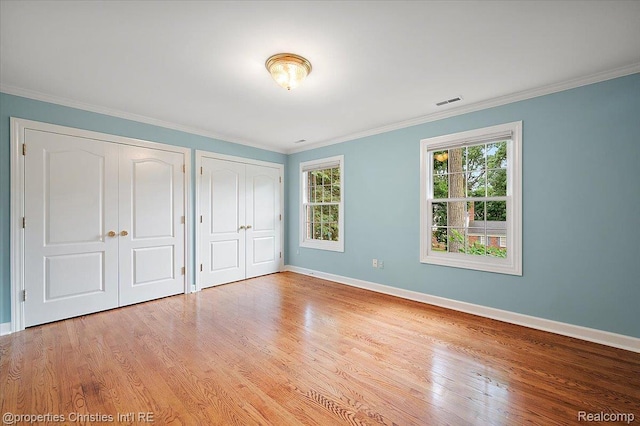 400 Hamilton Rd, Bloomfield, MI 48301 - unfurnished bedroom with multiple closets, wood finished floors, and ornamental molding