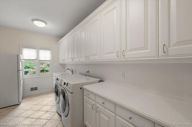 400 Hamilton Rd, Bloomfield, MI 48301 - laundry area with cabinet space, washer and clothes dryer, and light tile patterned flooring