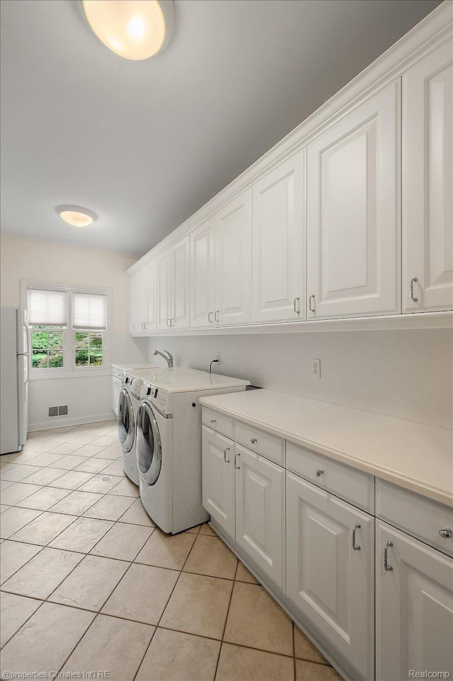400 Hamilton Rd, Bloomfield, MI 48301 - washroom featuring cabinet space, separate washer and dryer, and light tile patterned flooring