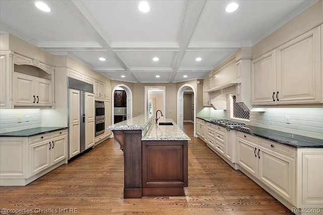 400 Hamilton Rd, Bloomfield, MI 48301 - kitchen featuring arched walkways, recessed lighting, appliances with stainless steel finishes, a center island with sink, and decorative backsplash