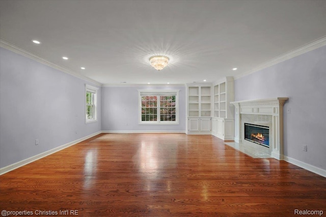 400 Hamilton Rd, Bloomfield, MI 48301 - unfurnished living room featuring ornamental molding, wood finished floors, a premium fireplace, built in shelves, and recessed lighting