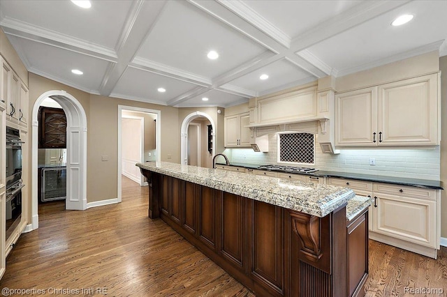 400 Hamilton Rd, Bloomfield, MI 48301 - kitchen with arched walkways, coffered ceiling, dark wood-type flooring, stainless steel gas stovetop, and tasteful backsplash