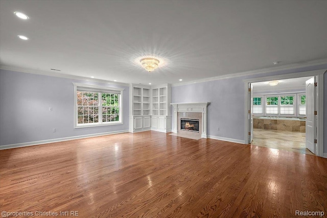 400 Hamilton Rd, Bloomfield, MI 48301 - unfurnished living room featuring ornamental molding, healthy amount of natural light, wood finished floors, recessed lighting, and a fireplace