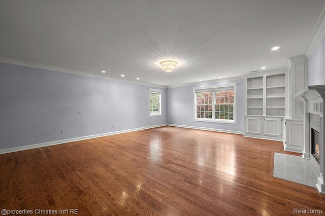 400 Hamilton Rd, Bloomfield, MI 48301 - unfurnished living room with a fireplace with flush hearth, crown molding, wood finished floors, recessed lighting, and built in shelves