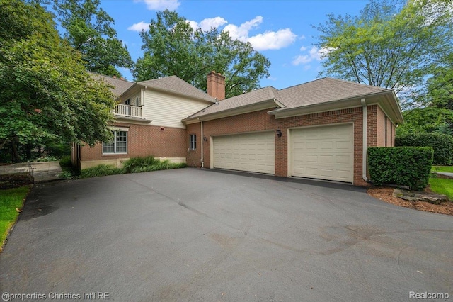 400 Hamilton Rd, Bloomfield, MI 48301 - view of front of property with asphalt driveway, an attached garage, brick siding, and a chimney