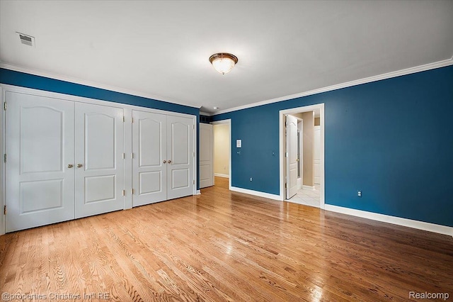 400 Hamilton Rd, Bloomfield, MI 48301 - unfurnished bedroom featuring crown molding, light wood finished floors, and two closets