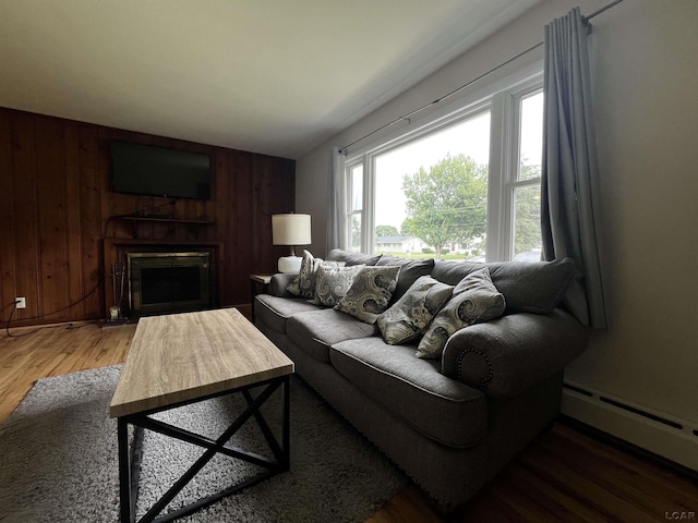 2682 Elmwood Dr, Adrian, MI 49221 - living room featuring baseboard heating, wooden walls, wood finished floors, and a fireplace