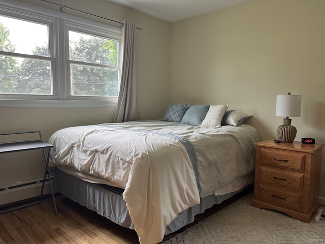2682 Elmwood Dr, Adrian, MI 49221 - bedroom featuring a baseboard radiator and wood finished floors