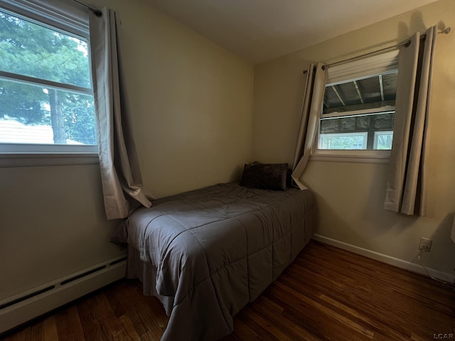 2682 Elmwood Dr, Adrian, MI 49221 - bedroom with baseboard heating, wood finished floors, and vaulted ceiling