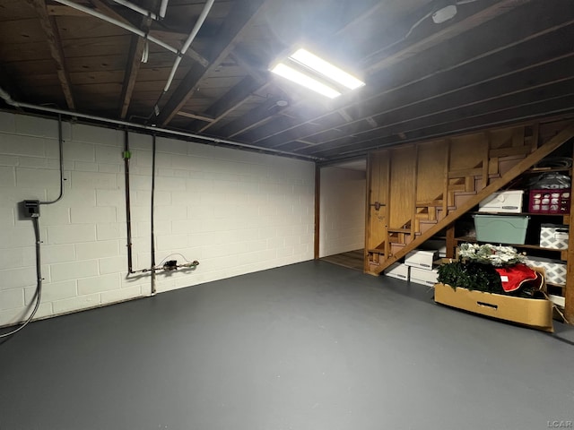 2682 Elmwood Dr, Adrian, MI 49221 - basement featuring stairs and concrete block wall