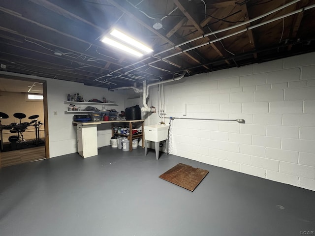 2682 Elmwood Dr, Adrian, MI 49221 - unfinished below grade area with concrete block wall and a sink
