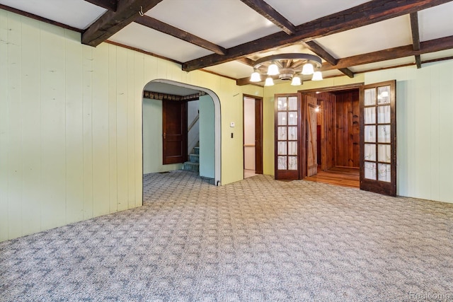4415 Central St, Columbiaville, MI 48421 - carpeted spare room featuring coffered ceiling, arched walkways, beamed ceiling, a chandelier, and stairs