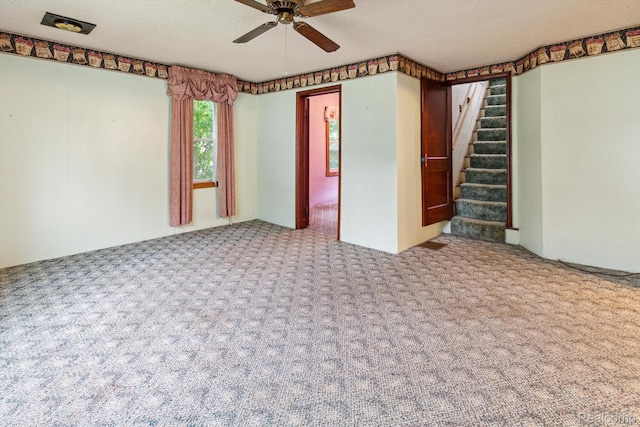 4415 Central St, Columbiaville, MI 48421 - spare room featuring carpet flooring, a ceiling fan, stairway, and a textured ceiling
