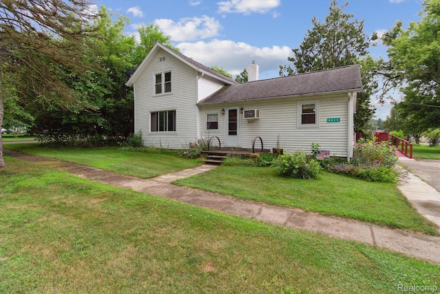 4415 Central St, Columbiaville, MI 48421 - traditional-style house featuring a front yard and a chimney