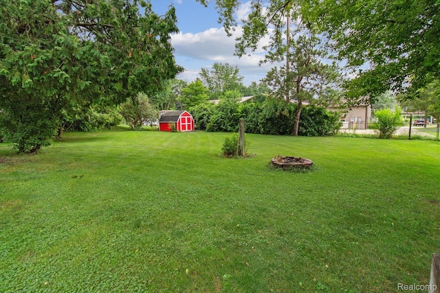 4415 Central St, Columbiaville, MI 48421 - view of yard with a storage shed and an outdoor fire pit