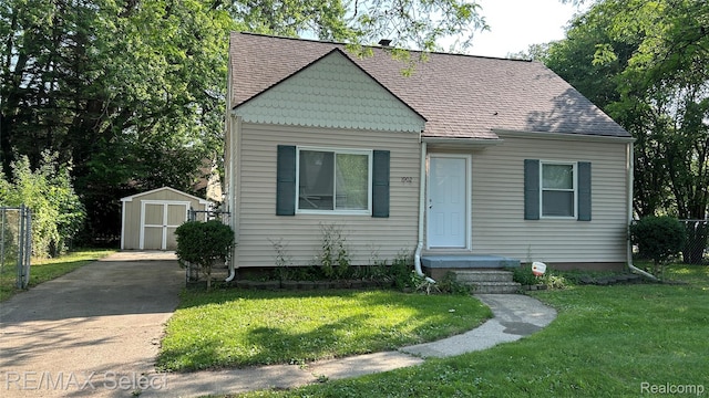 1902 Crestbrook Ln, Flint, MI 48507 - bungalow-style home featuring a storage shed, concrete driveway, and a shingled roof