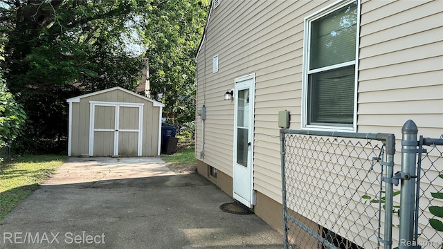 1902 Crestbrook Ln, Flint, MI 48507 - view of property exterior with a shed, a gate, and a patio area