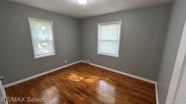 1902 Crestbrook Ln, Flint, MI 48507 - spare room featuring dark wood-style flooring and baseboards