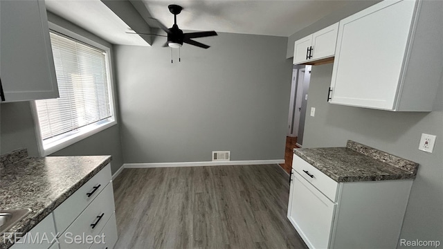 1902 Crestbrook Ln, Flint, MI 48507 - kitchen with ceiling fan, dark wood-style floors, white cabinetry, and dark countertops